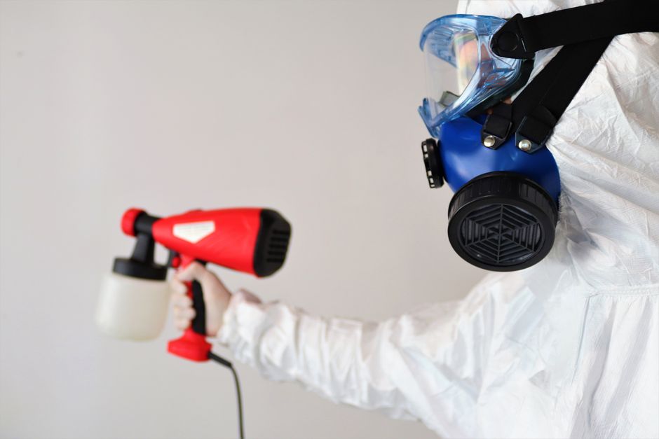 Technician applying antimicrobial treatment as part of a mold remediation job